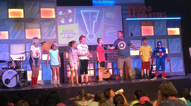 Kids on stage during an event led by Jared Wockenfuss