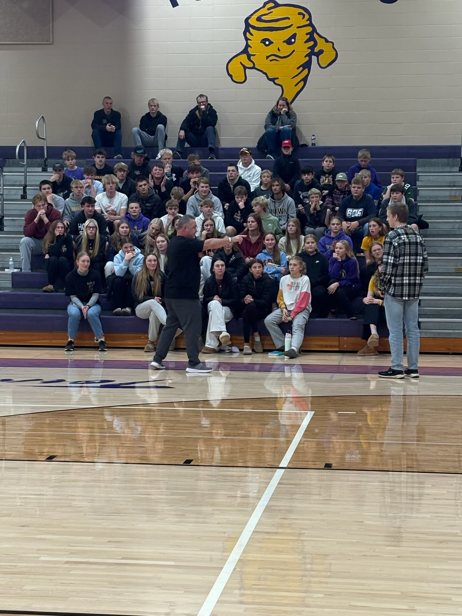 A full gym of students and families at an event with Jared Wockenfuss